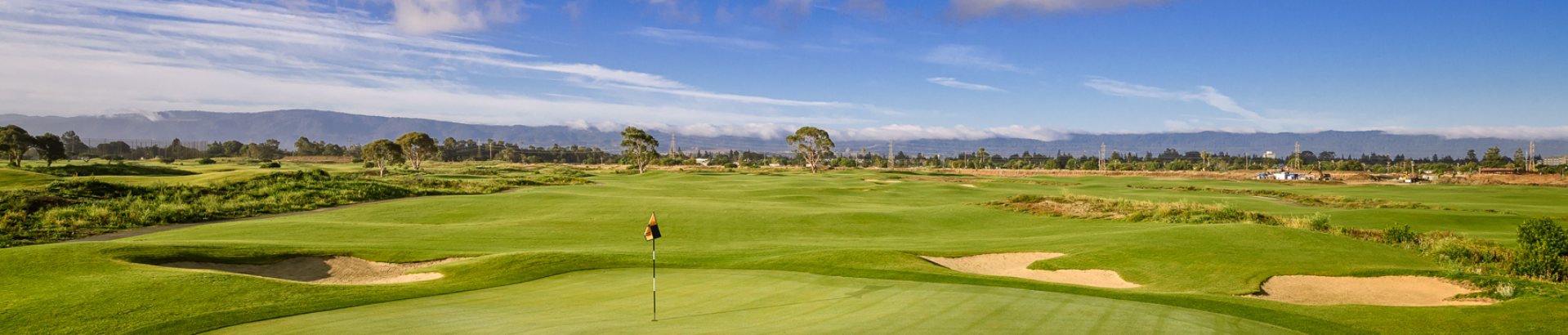 Image of golf ball on tee on grass.